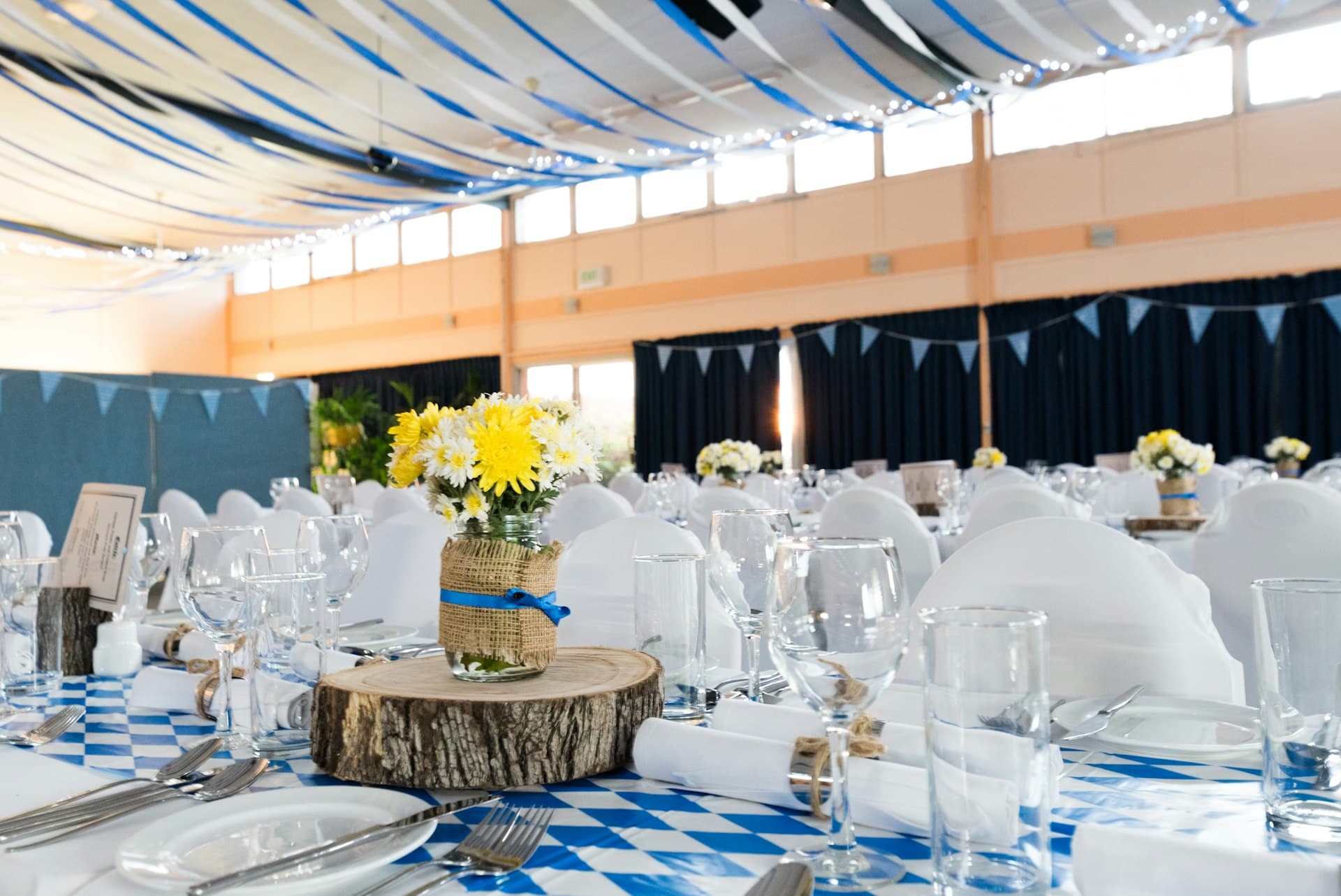 Function hall under a draped fabric canopy with set tables